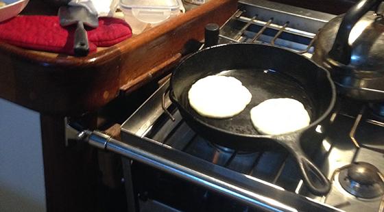 Pancakes in cast iron underway pancakes cooking on stove
