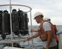 Matt Garrett of the Florida Fish and Wildlife Conservation Commission, who managed the ECOHAB project, handles a rosette of Niskin bottles, which are used to collect water samples from various depths. Photo credit: Mote Marine Laboratory Florida Fish and Wildlife Conservation Commission, ECOHAB project, Niskin bottles