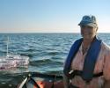 Dr. L. Kellie Dixon of Mote Marine Laboratory conducts research as a Co-Principle Investigator on the ECOHAB project. Behind her is a "mesocosm" system designed by collaborator Matt Garrett of FWC to study phytoplankton growth in partially controlled conditions but under ambient temperature and sunlight. Photo credit: FWC Dr. L. Kellie Dixon, mesocosm