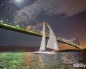 GryphonSolo2 sailing under the Verrazano Bridge in the final push up to the finish line in New York. Photo by Billy Black GryphonSolo2, Sailing, Atlantic Cup, Verrazano Bridge, New York