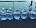 Hinckley Water provided five gallon jugs of water that could be used on the water and on the event site. Competitors used dolphin pumps to fill up their reusable water bottles, cutting down on the amount of wasted plastic. 5 gallon jug, water station,